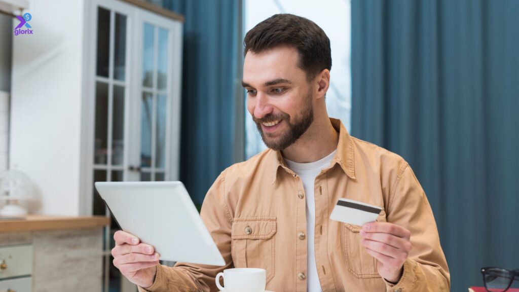 Person smiling while tracking credit score progress on a laptop in a cozy home office