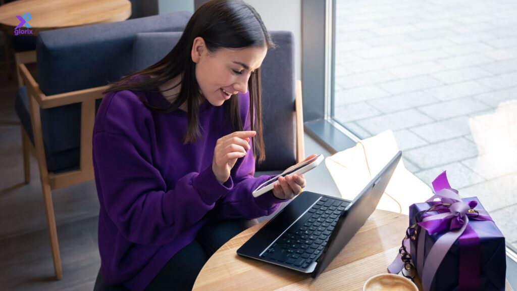Smiling young adult confidently reviewing credit score and financial notes on a laptop at home