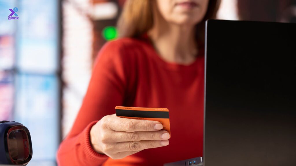 Person managing a secured credit card online to build a credit score in the USA